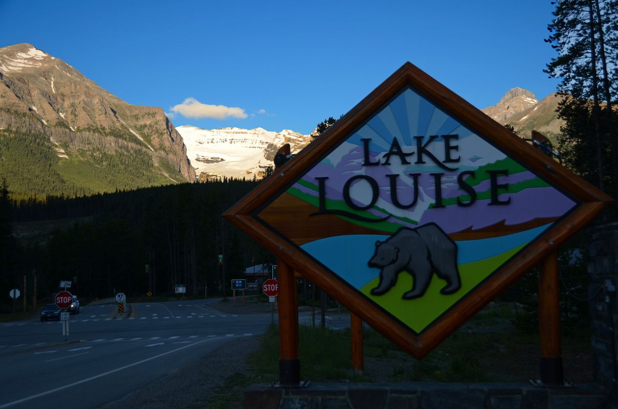 01 Welcome To Lake Louise Sign With Fairview Mountain, Mount Victoria, Mount Whyte Early Morning From Lake Louise Village